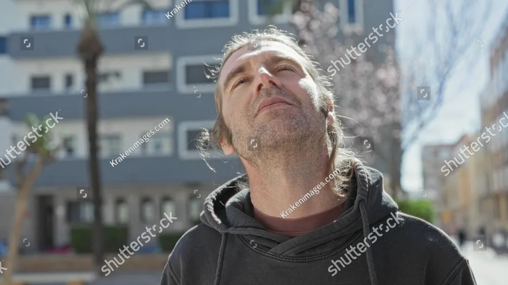 A man with his eyes closed and his face turned to the sky